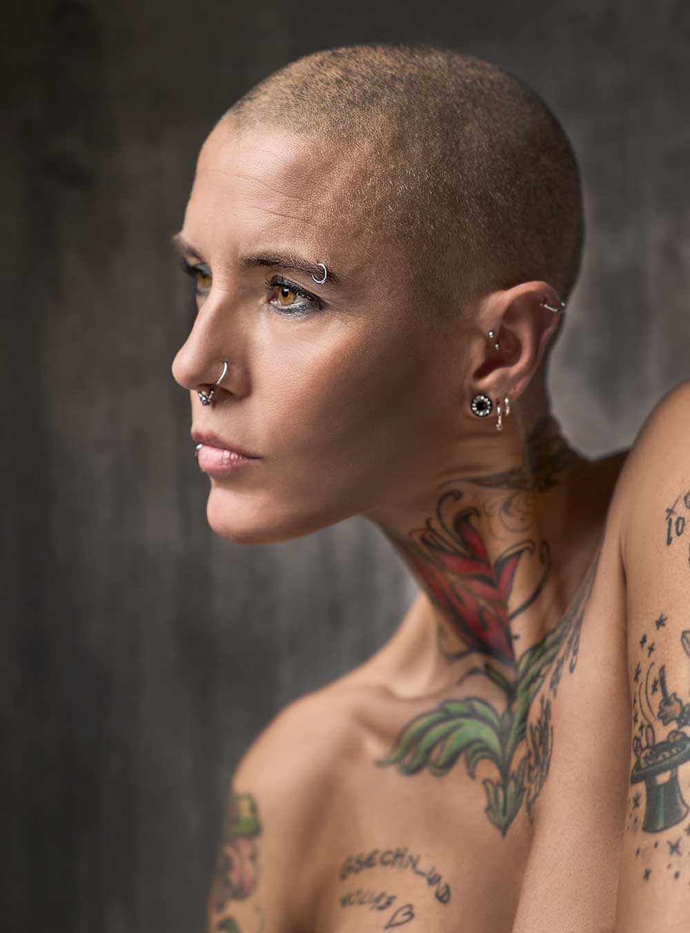 Portraitfotografie Frau mit Glatze und Tattoos.